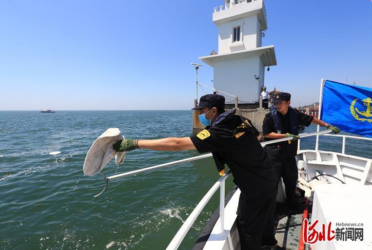 清污人员打捞吸油毡清除溢油。 通讯员魏伟摄