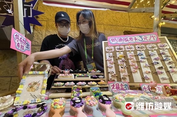 刘炳熙(左)和彭晓丹正在整理自己售卖的手工饰品。