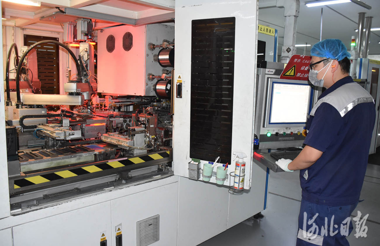 晶澳（邢台）太阳能有限公司的焊机操作员正在调试设备。