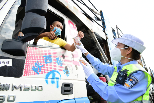 过路大车司机检查“两扫三查一问”后,为交警点赞。