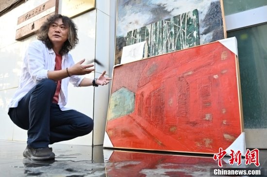9月2日，甘肃兰州，西北民族大学美术学院副教授刘志刚在自己的作品与画稿前讲述自己的创作理念。刘志刚表示，他们所创作的漆画内容不少都与敦煌艺术、边塞文化相关联，让大家看到作品后就会有种行走在诗歌中的感受。中新社记者 李亚龙 摄