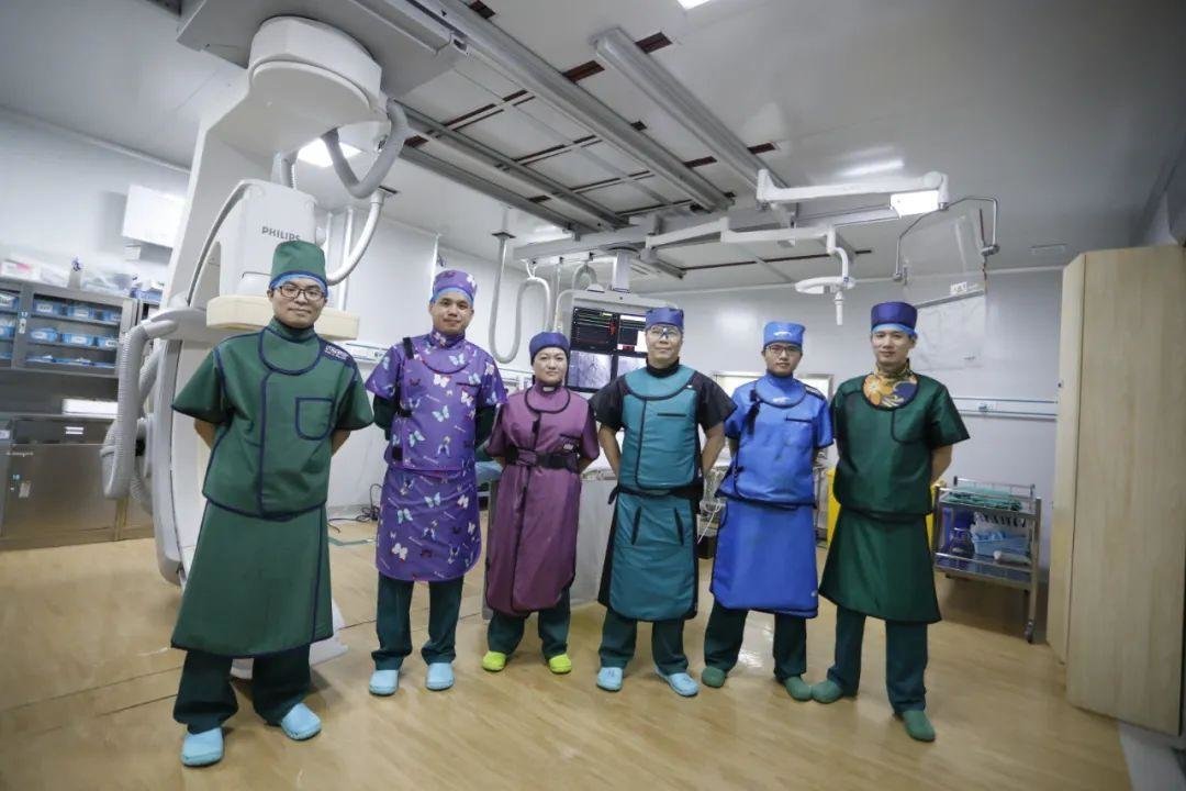 李滨（左二）是省二院心内科主治医师，平时常身穿铅衣跟同事一起为心血管病患者做急性心梗开通血管等微创介入手术。