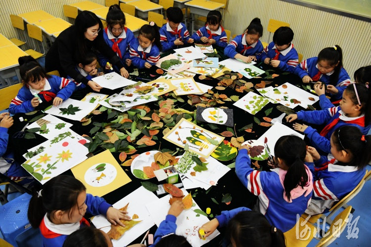 10月21日，广平县广平小学的老师在给学生讲解制作树叶贴画的方法。