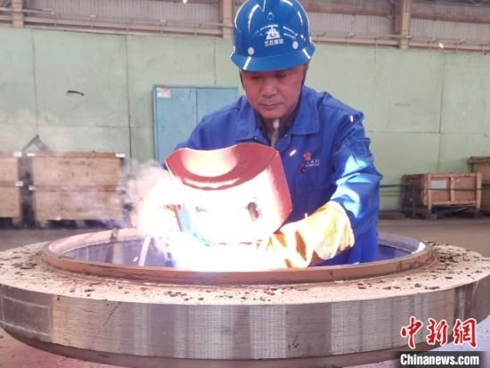 图为魏本强在车间第一线焊接产品（资料图）兰石集团供图