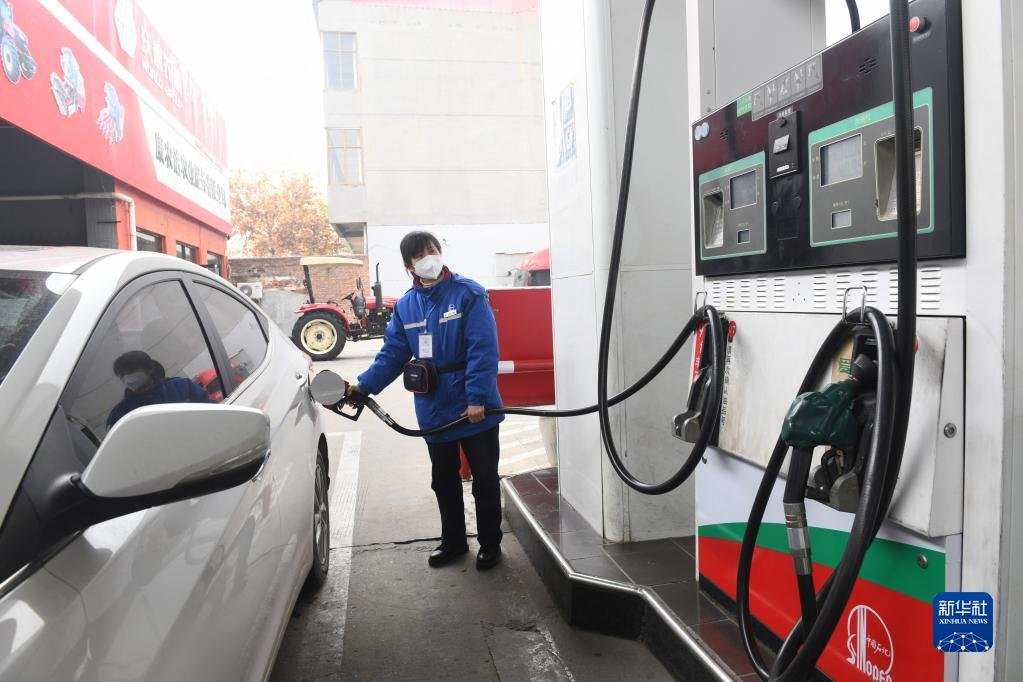 11月21日,河北省新乐市一家加油站的工作人员给汽车加油
