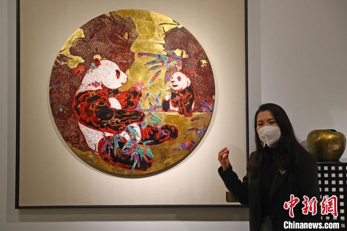 图为江西景德镇东方大漆艺术中心主任陆辰琳正在介绍展出的漆画艺术作品《紫气东来》。　刘占昆 摄