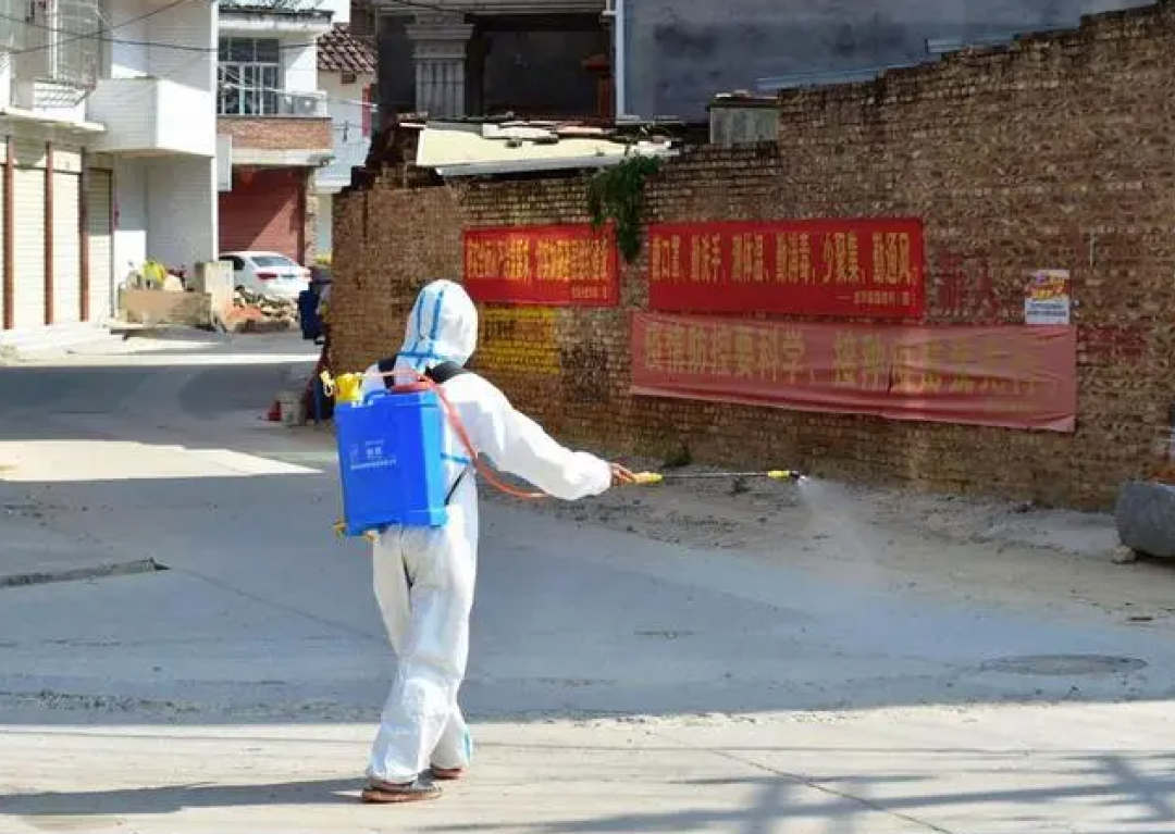 某村志愿者对村道进行消杀。图源:新华社