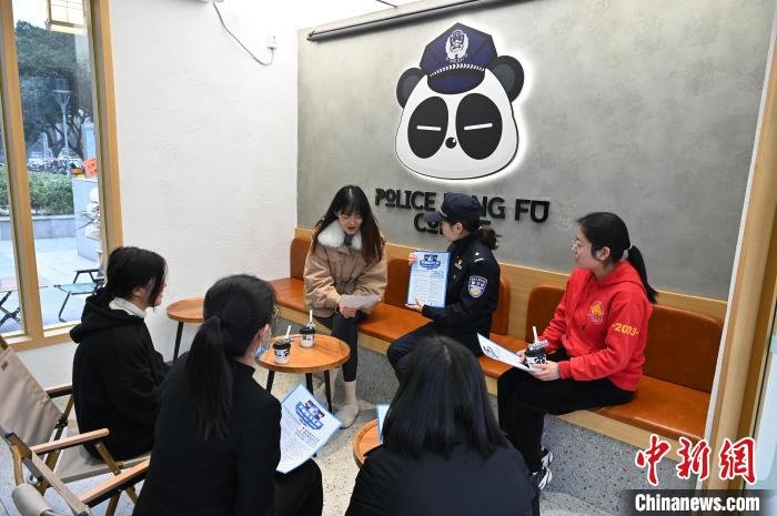 民警在咖啡店进行反诈知识宣传。　安源 摄