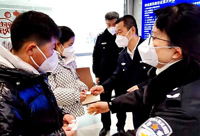 图为1月18日,在西安市公安局未央分局,民警向户籍在山西的姐弟俩发放首次办好的身份证。