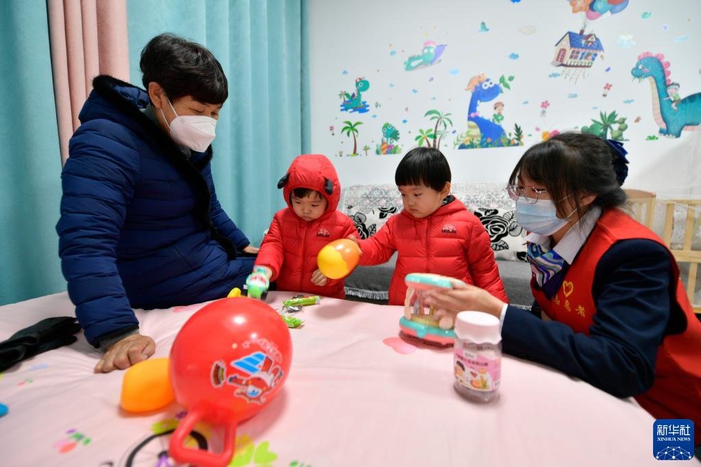 在武威市政府政务服务中心母婴休息室，志愿者（右一）陪伴小朋友玩耍（2月17日摄）。新华社记者 范培珅 摄