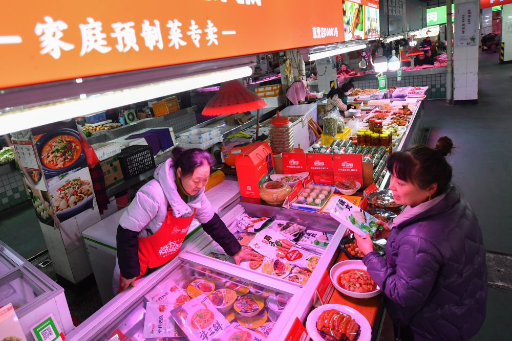 2月24日，消费者（右）在浏阳市圭斋路生鲜市场挑选预制菜。