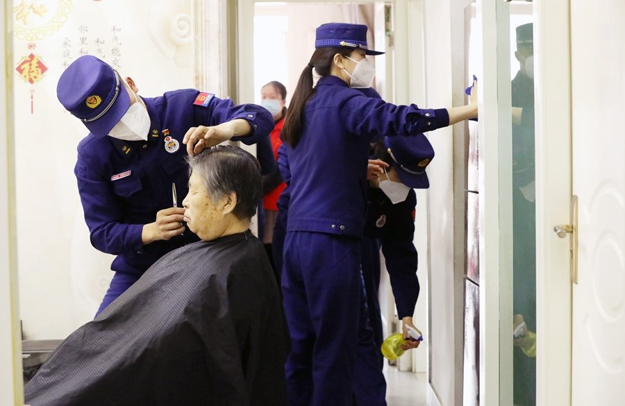 文明实践活动中，森林消防员为老人理发。悲海博 摄