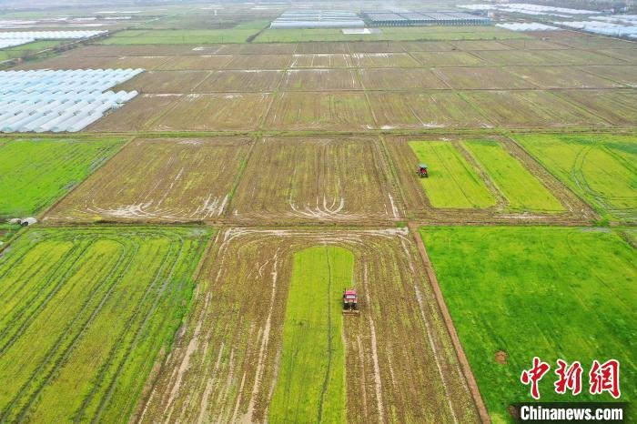 图为航拍江西上高县的广袤田野，几台农机正在翻耕土地，留下了一道“春日印记”。　陈旗海 摄