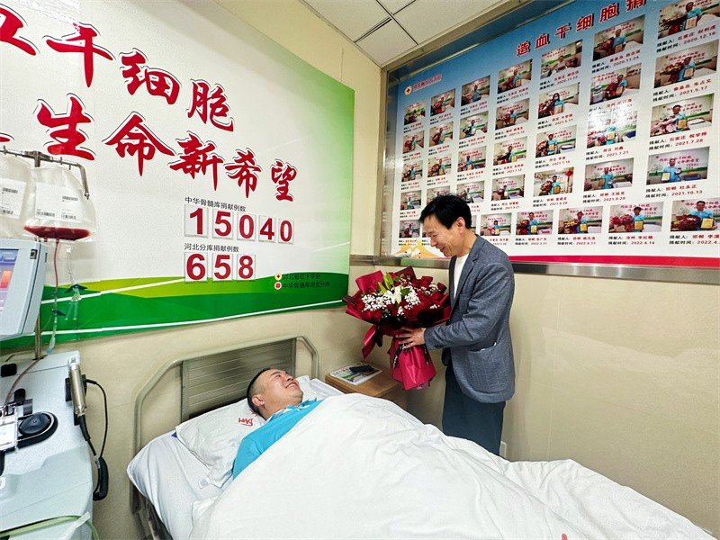 河北省红十字会三献工作事务中心工作人员张新军为刘勇送上鲜花。 周颖摄
