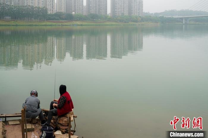 男女两位市民在邕江岸边垂钓。　王以照 摄