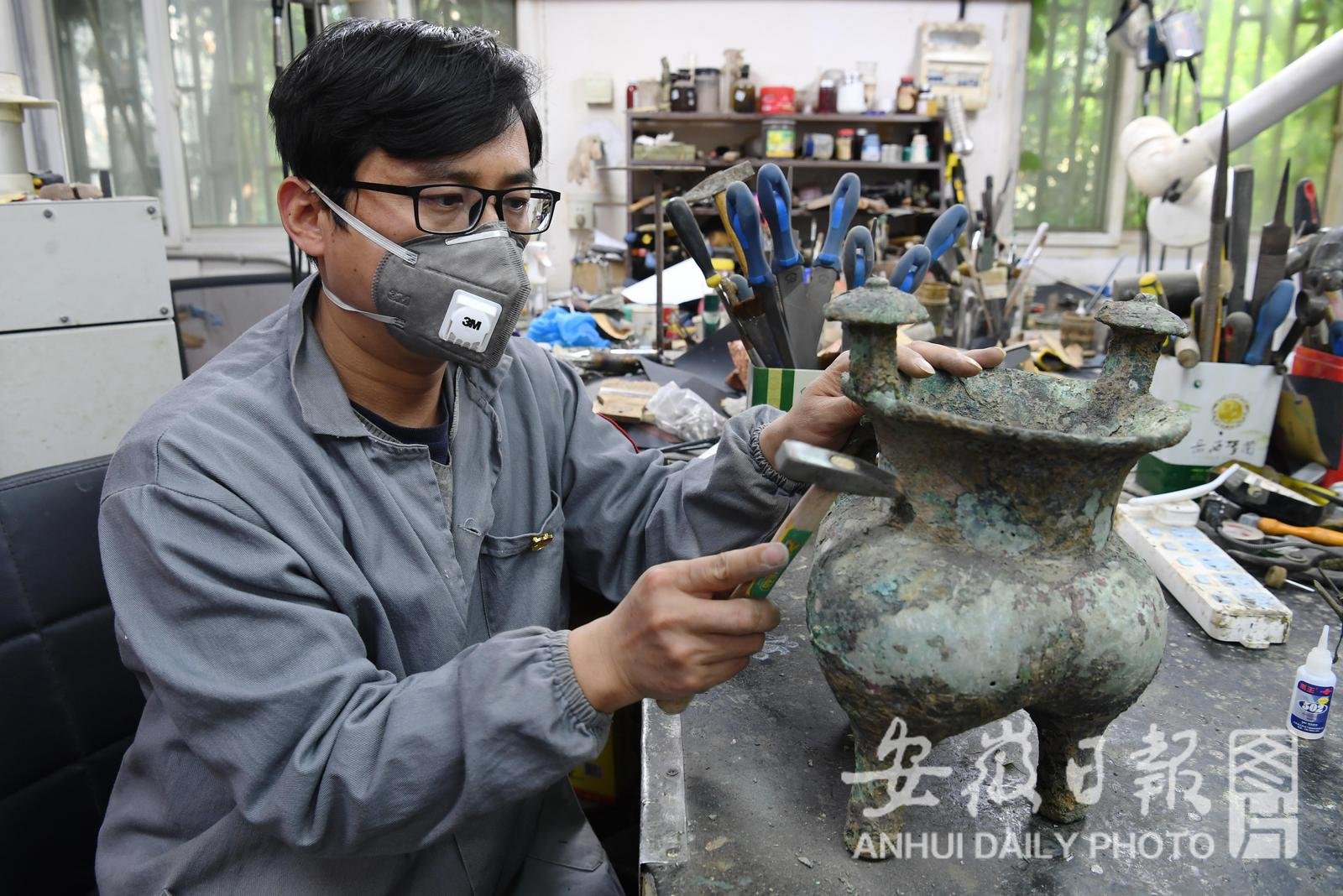 4月26日，在省博物院文物科技保护中心青铜修复室，39岁的李瑞亮修复商牛首鋬铜斝。