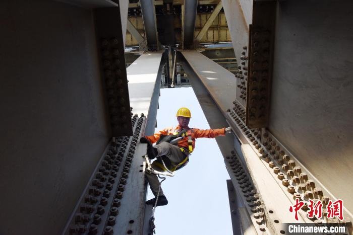 5月1日,九江桥工段桥隧工攀爬京九铁路九江长江大桥钢梁,检查钢梁螺栓