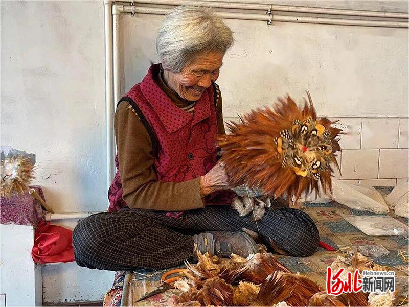 图为河北省滦南县姚王庄镇张麻湾村老手艺人扎制鸡毛掸子。