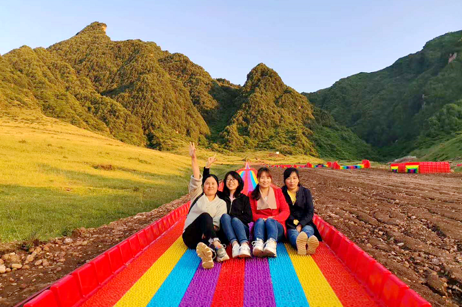 ▲游客打卡七彩的滑草跑道