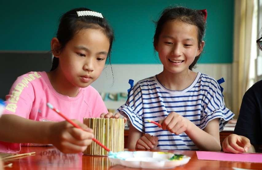 （6月2日，在肥西县铭传乡中心学校，学生用秸秆制作环保手工艺品。 刘少芬 摄）