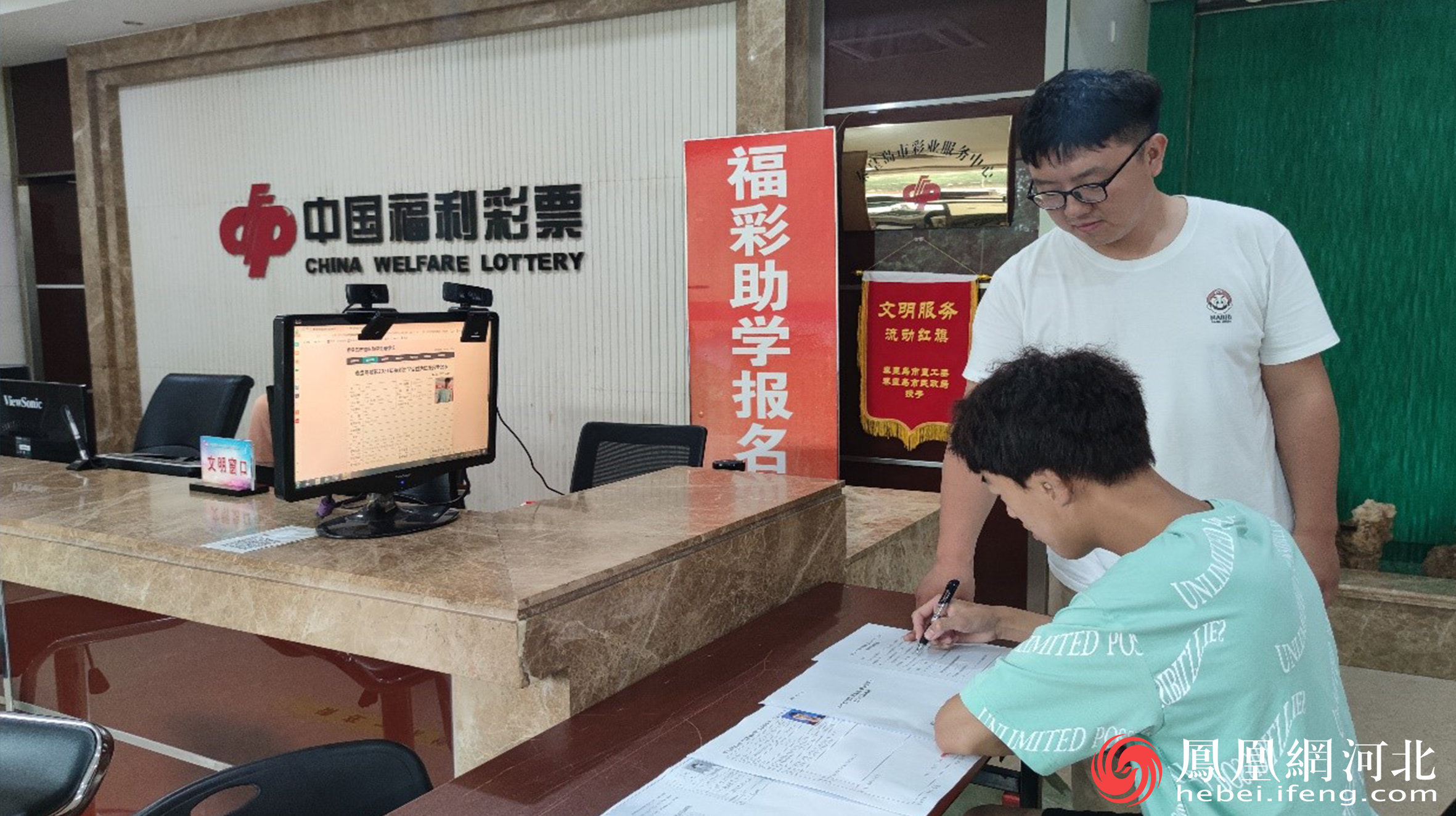 工作人员为学生解释报名流程