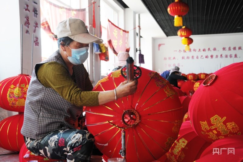 工人为宫灯拉金条(央广网记者 李红军 摄)