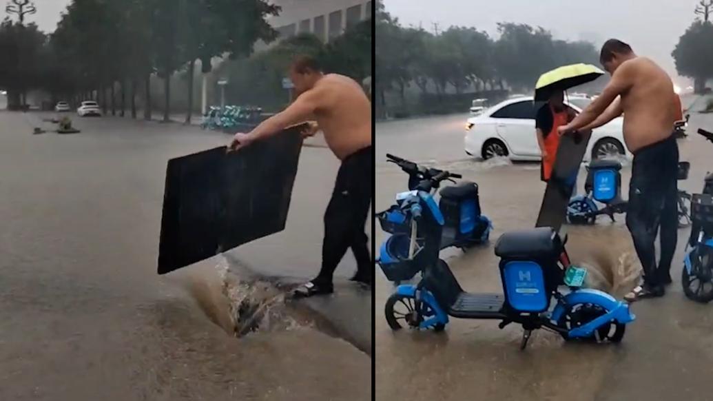 雨水覆盖路面大坑，夫妇设置障碍提醒路人避开