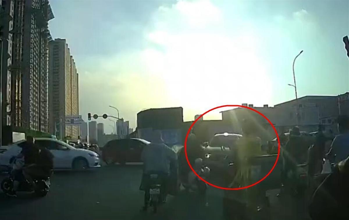 红圈内为闯红灯后横穿马路的肇事车辆。(车载记录仪视频截图)