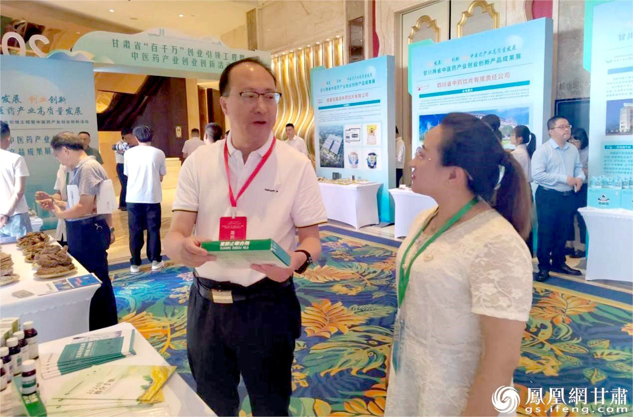甘肃药业集团党委委员、副总经理张世俊（前左）参观展台 贾继喜 摄