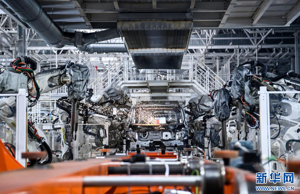 红旗繁荣工厂焊装车间内，焊装机器人在生产线上焊接车身。新华社发