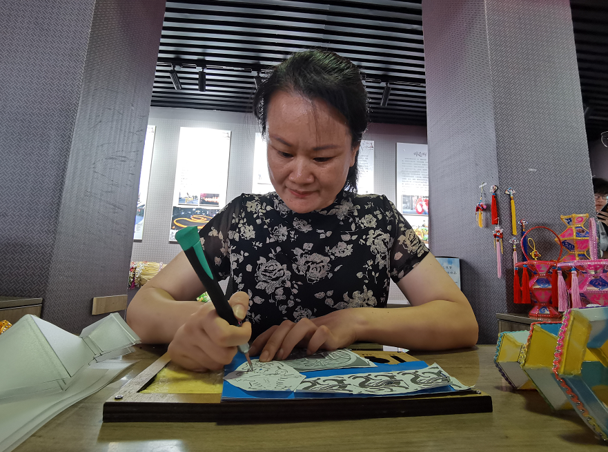 国家级非遗项目石城灯会传承人黄帅英正在刻画（李梦丽 摄）