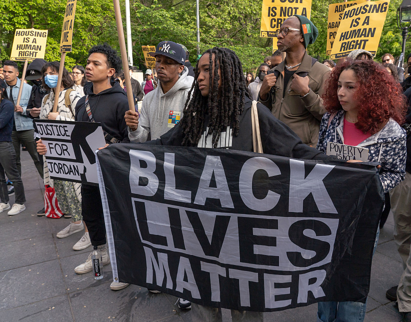 当地时间2023年5月5日，美国纽约，在华盛顿广场公园举行的“为乔丹·尼利伸张正义”集会上，一名妇女举着“黑人的命也是命”横幅。