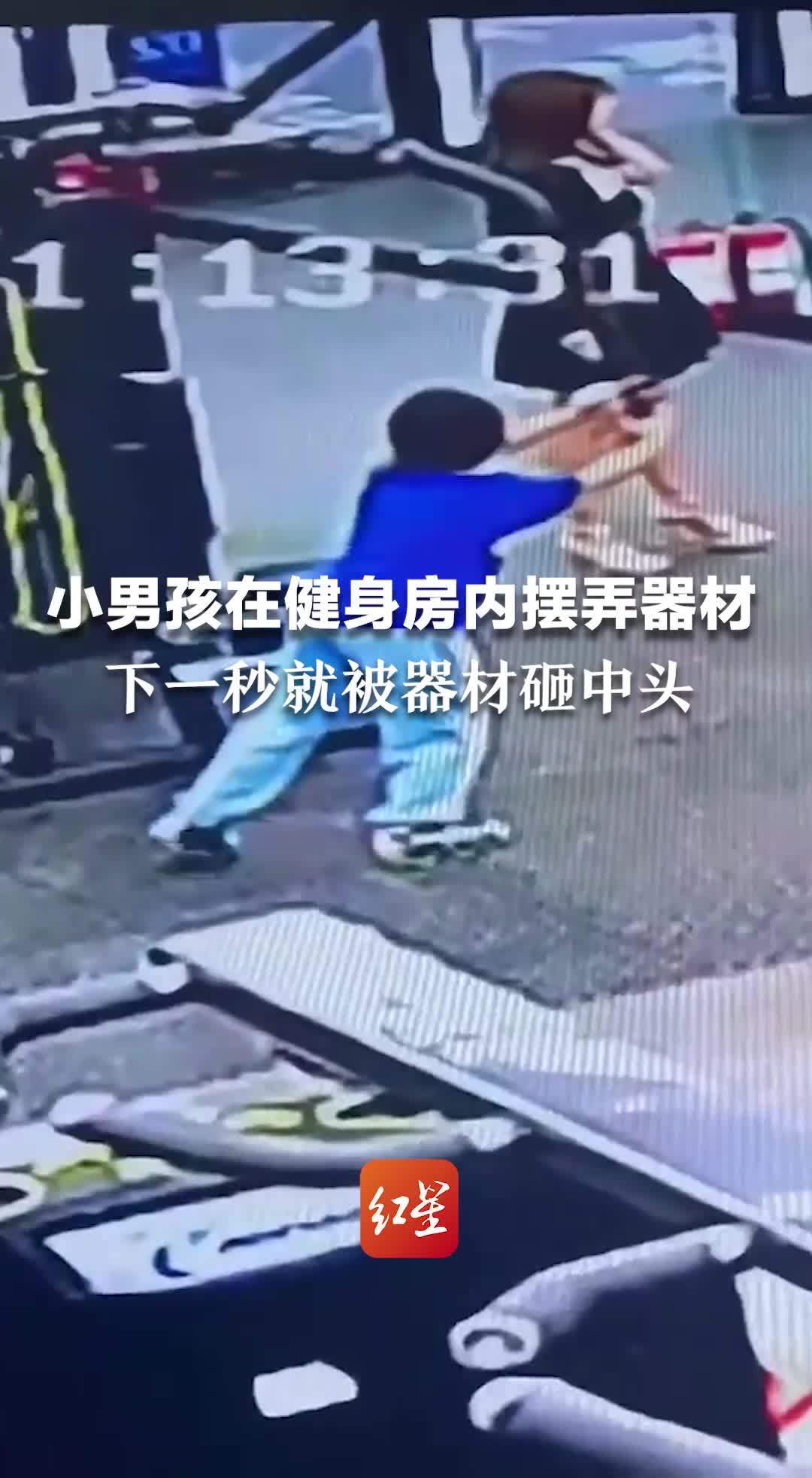 小男孩在健身房内摆弄器材，下一秒就被器材砸中头部