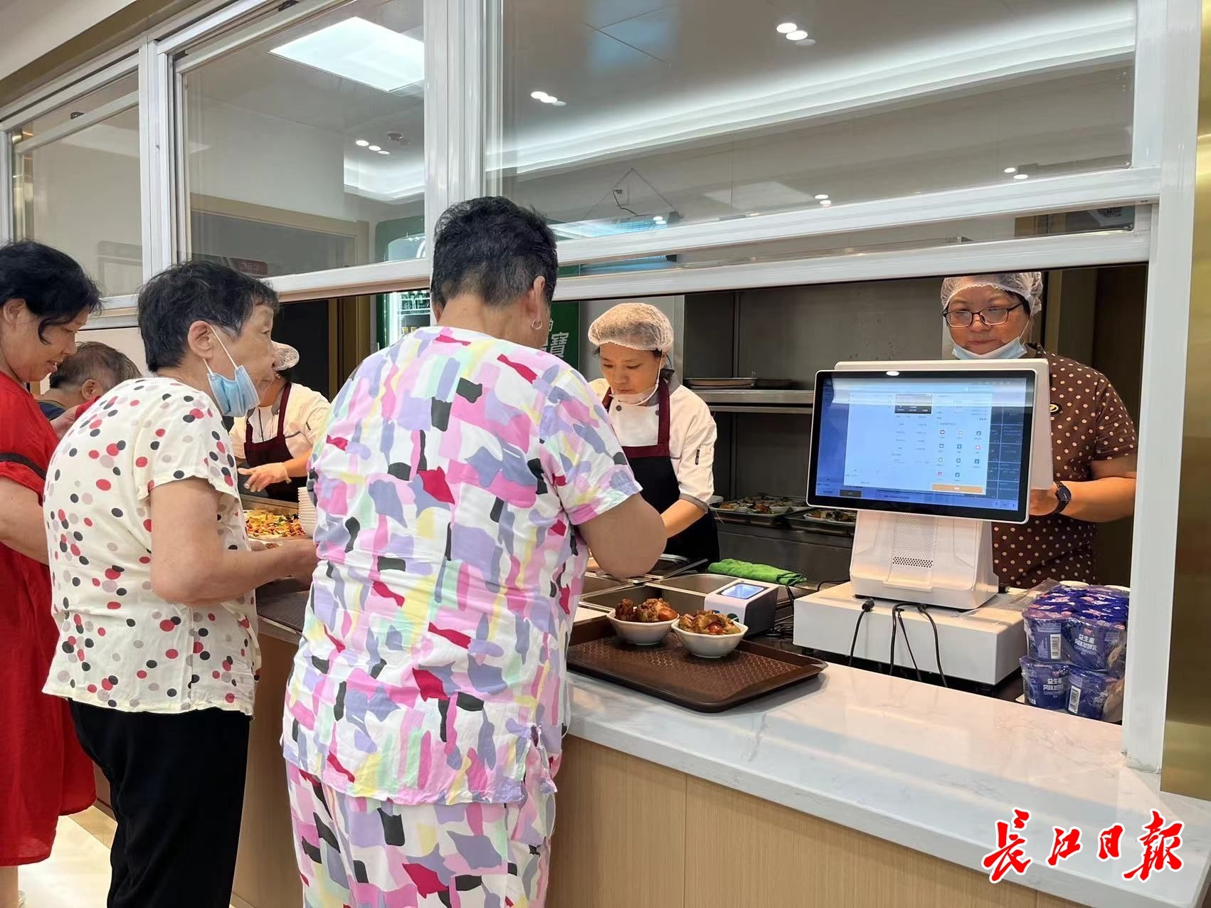 幸福食堂里的居民们正在排队。