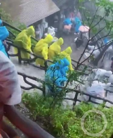 ▲大量游客冒雨下山。图片来源/视频截图