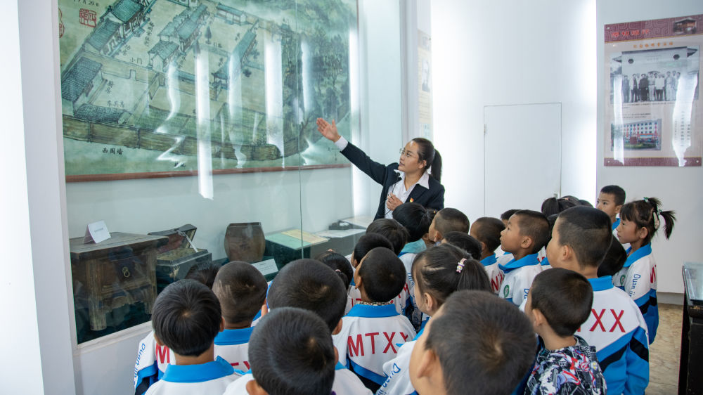 9月11日，明堂小学校长姚晓霞带领学生参观教育史陈列馆。（临洮县融媒体中心供图）
