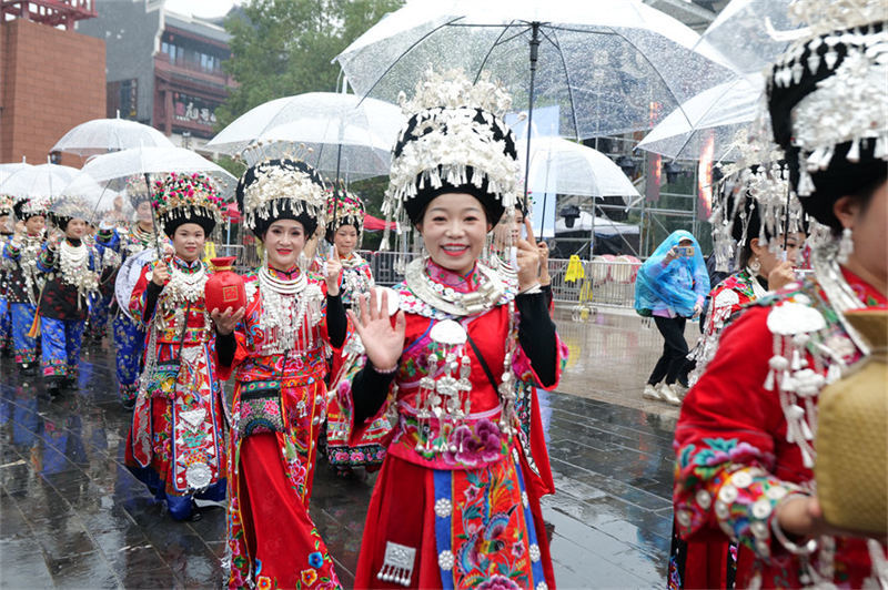 雨中，身穿盛装的苗家姑娘热情的打招呼。 吴东林摄