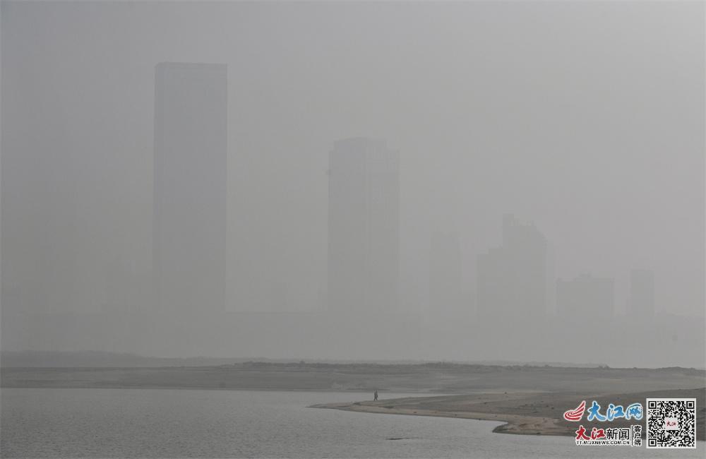 12月29日上午,镜头中赣江两岸的建筑物被雾霾笼罩。