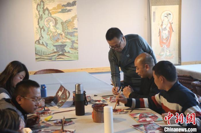 1月11日，在敦煌小镇鸣沙书院研学课堂，研学导师指导来自云南的学员临摹敦煌壁画。张晓亮　摄