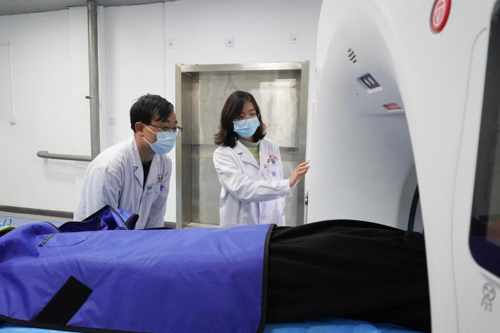 1月18日，在积石山县人民医院，山东省医疗人才“组团式”帮扶医疗队成员张金芝（右）为患者做检查。新华社记者　马希平　摄