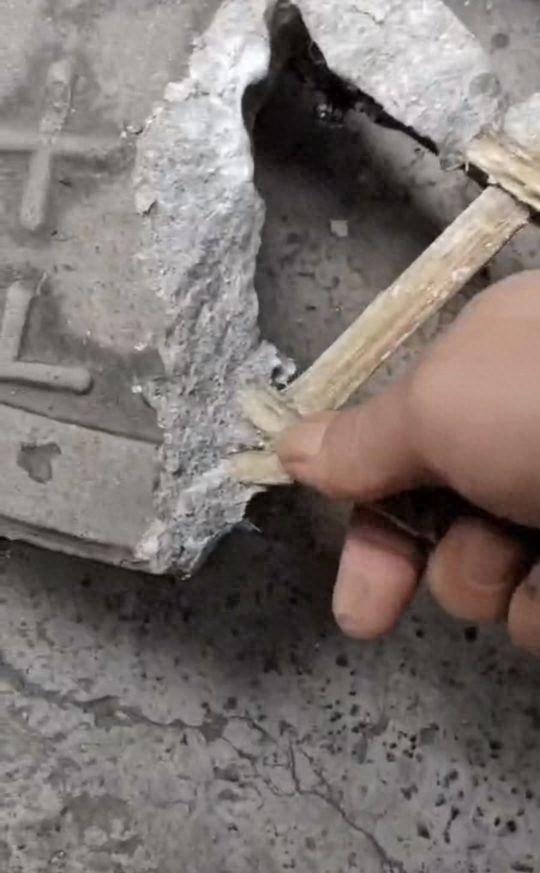 网友拍摄视频,指井盖用竹签替代钢筋。厂家称系复合材料制成。视频截图