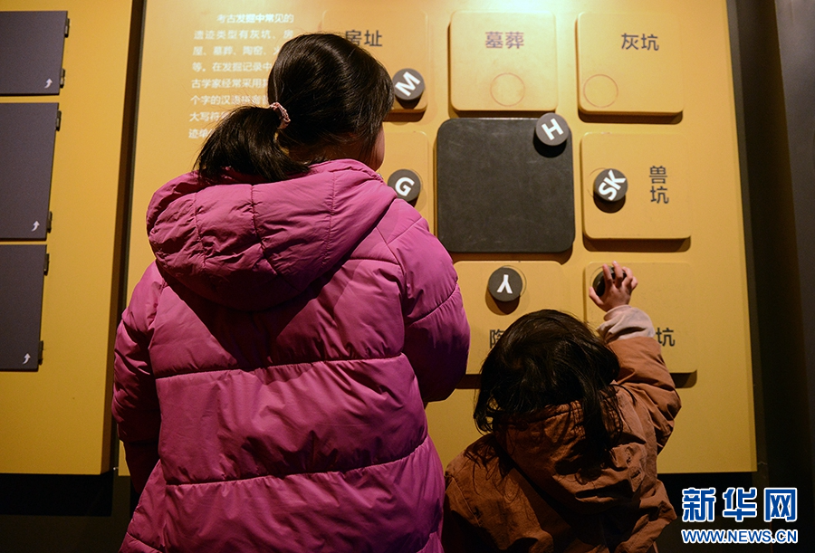 1月25日,河南省漯河市舞阳县贾湖遗址博物馆,游客在参与互动游戏。