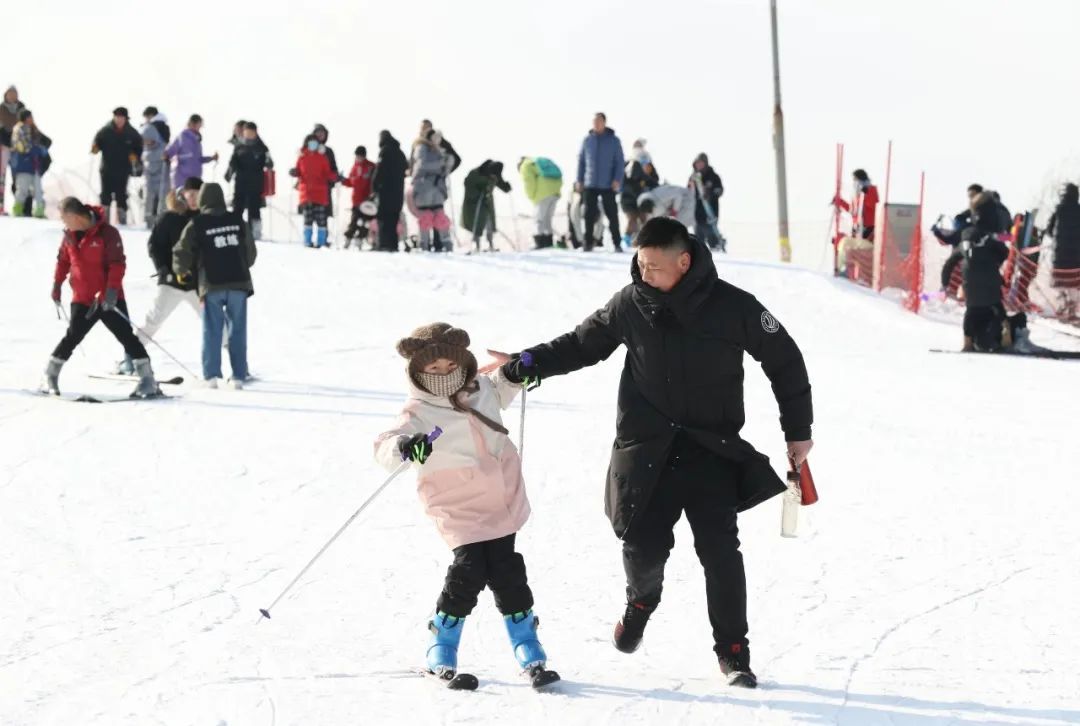 🔹2月11日，家长带着小朋友在宁夏银川一雪场滑雪。中新社记者 于晶 摄