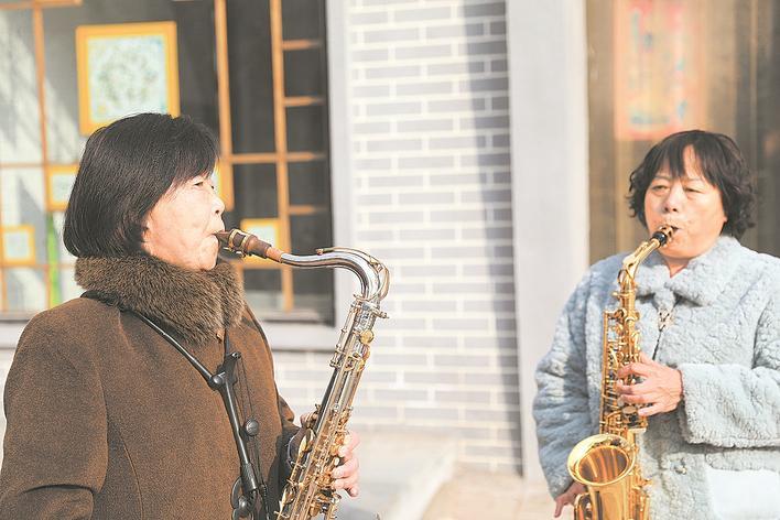周窝音乐小镇村民闲暇时在大街小巷演奏乐器。