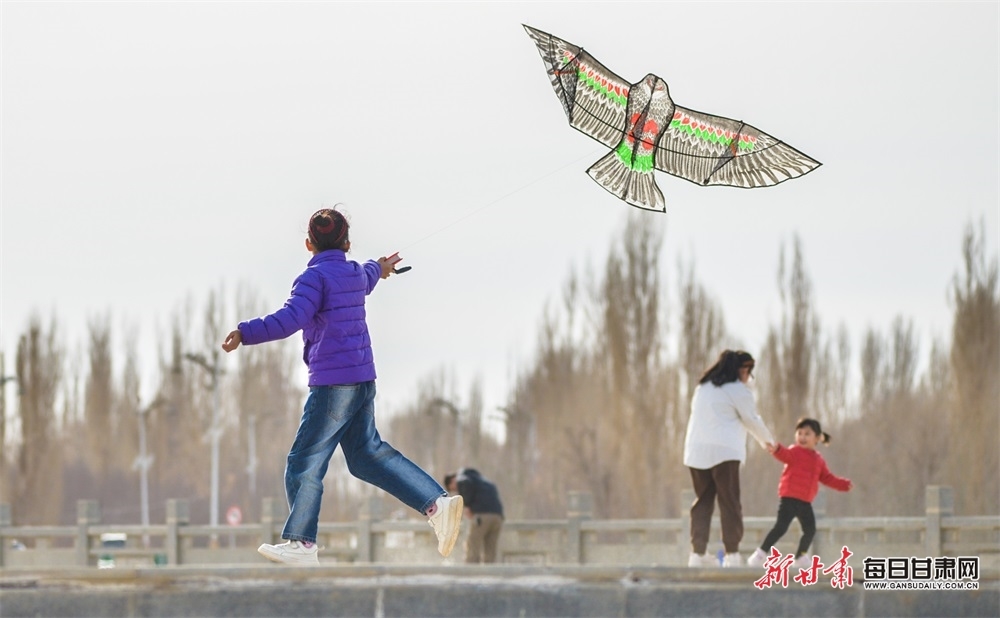 3月23日，市民在敦煌党河大桥附近放风筝。