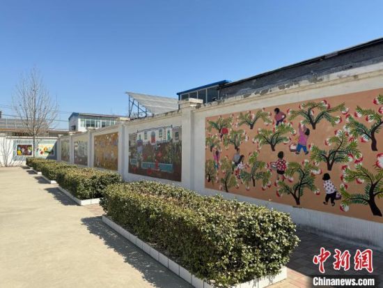 走在王下村，房前屋后的墙上都是村民们的农民画作品。　赵丹媚 摄