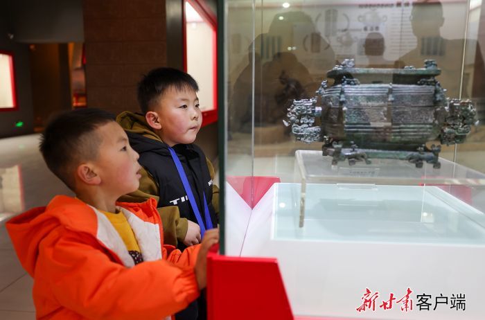 参观者在甘肃秦文化博物馆观看展出的蟠虺纹瓦棱纹盨　新甘肃·甘肃日报记者　冯乐凯