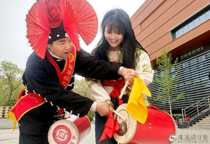 河西学院历史文化与旅游学院学生田振亚（右）学习凉州攻鼓子