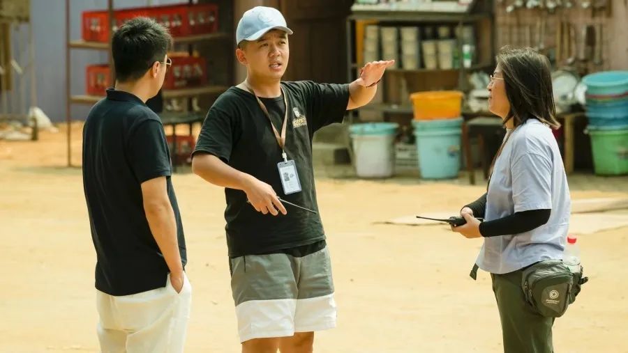 吴明正（中）在拍摄现场与剧组工作人员交流。（受访者供图）