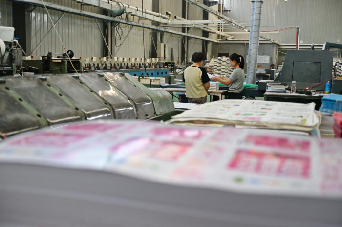 5月11日，河北省涿州市一家图书印刷企业的工人在装订车间内工作。